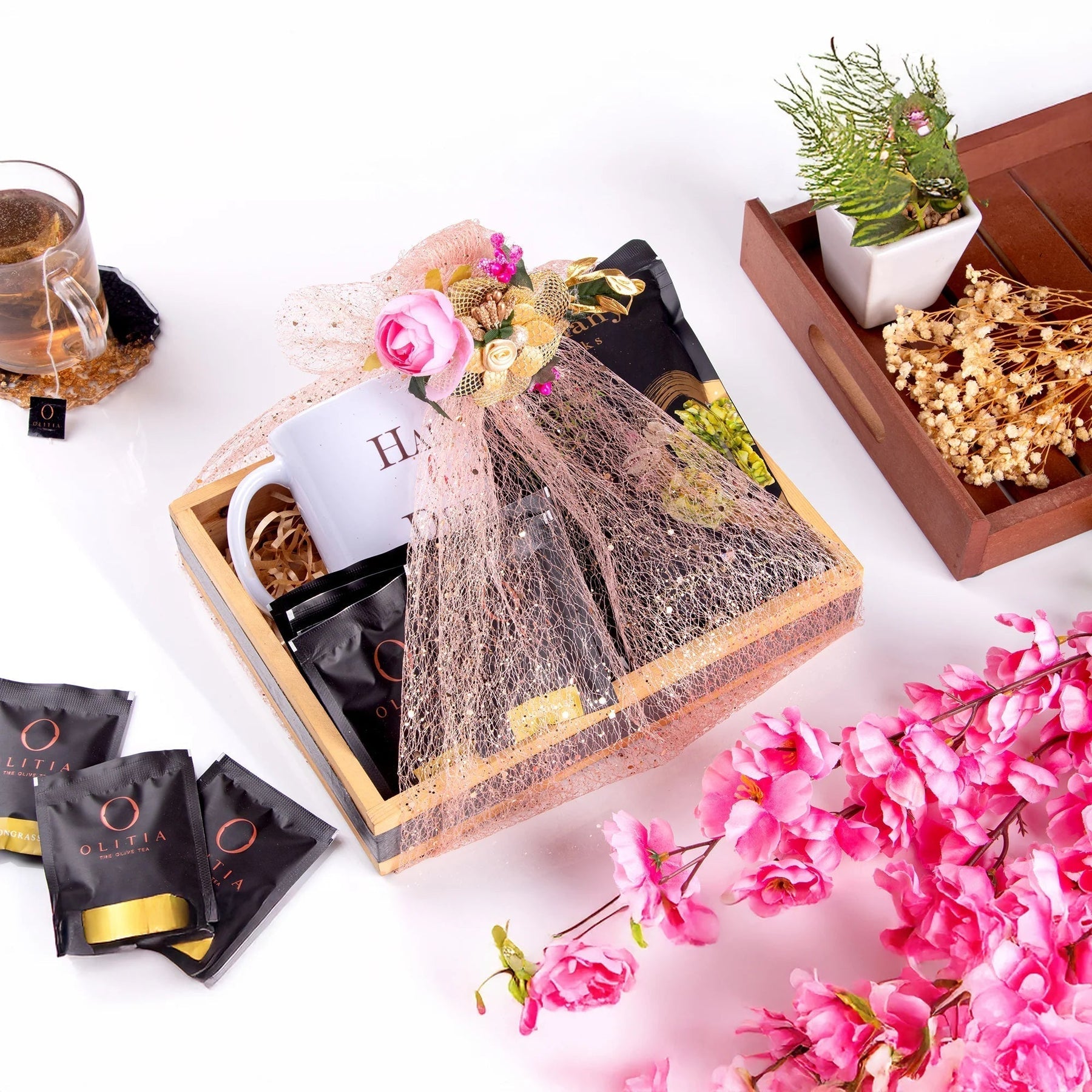 Elegant gift box with tea, mug, and flowers for joyful daily moments
