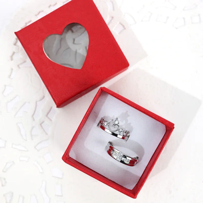Valentines Gift of Couple Ring Set in red heart-shaped box, featuring matching silver rings for partners with crown and diamond accents.