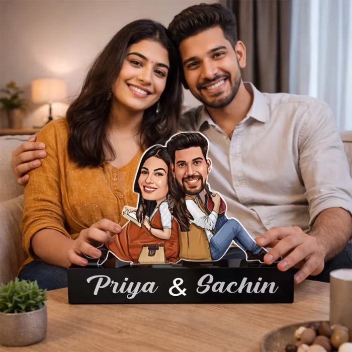 Personalized Couple Caricature Gift in MDF and acrylic featuring a smiling couple holding their custom caricature with names Priya & Sachin.