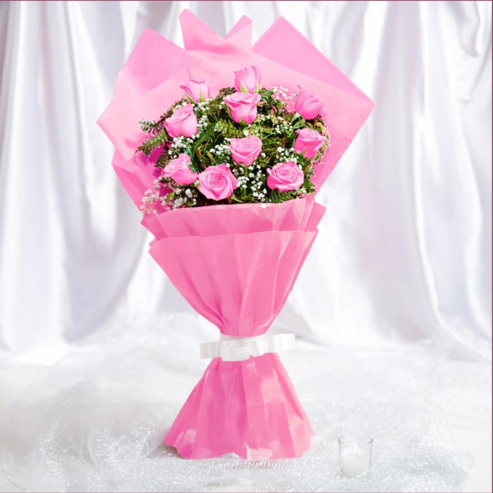 Pink roses bouquet with white baby's breath wrapped in pink paper