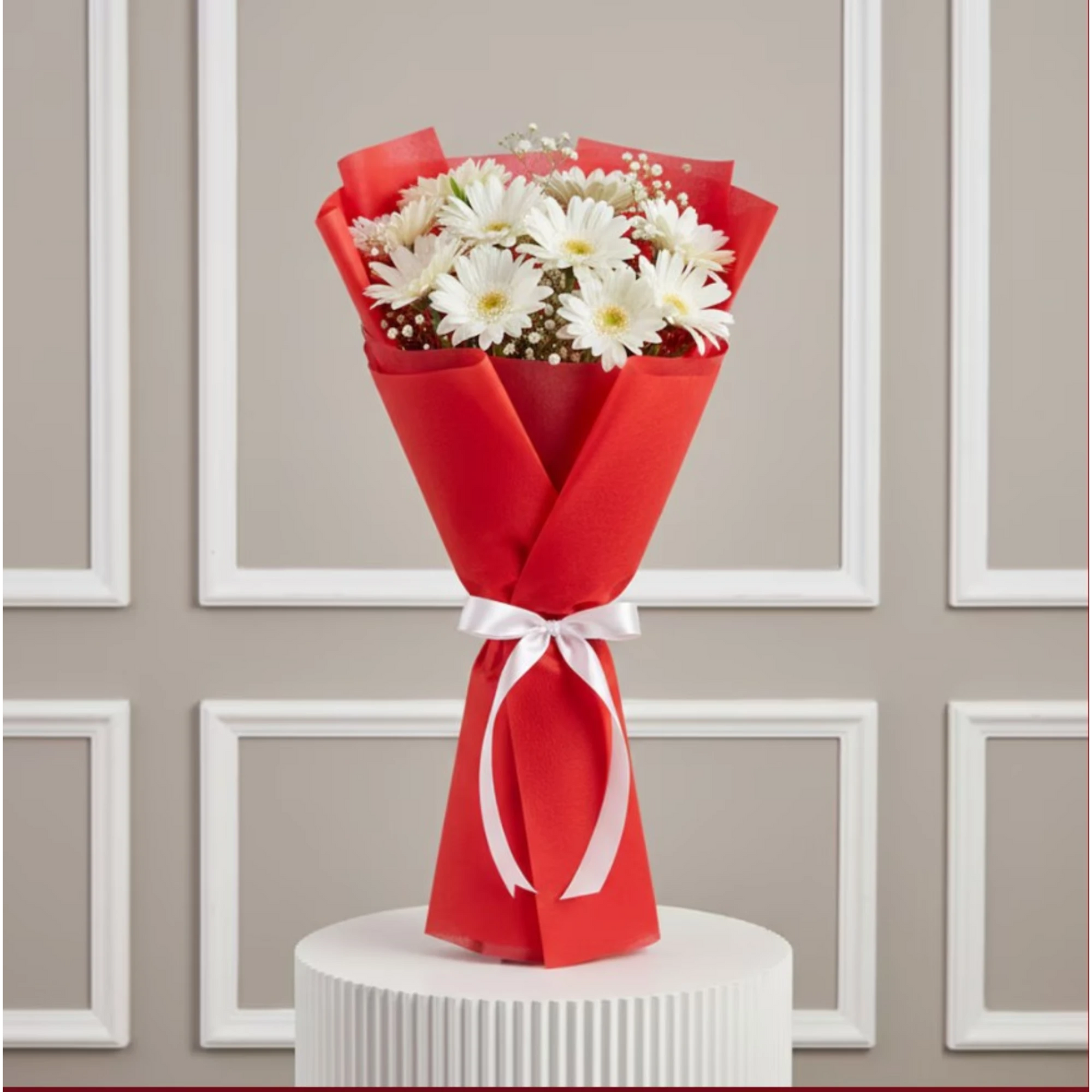 White daisies bouquet with red wrapping