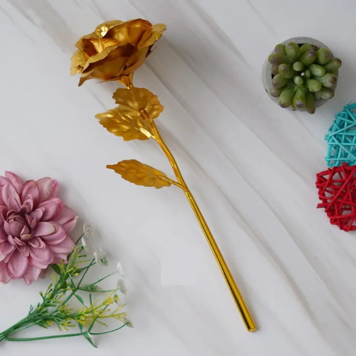 Gold plated rose gold gift for girlfriend, 25cm tall, displayed on marble surface with decorative flowers. Ideal for Valentine's Day.