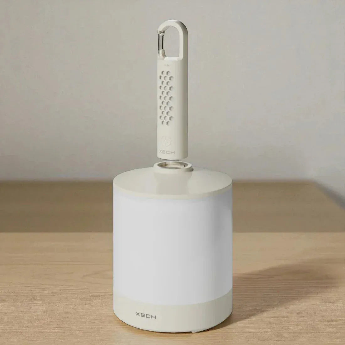White cleaning tool with a handle on a wooden surface