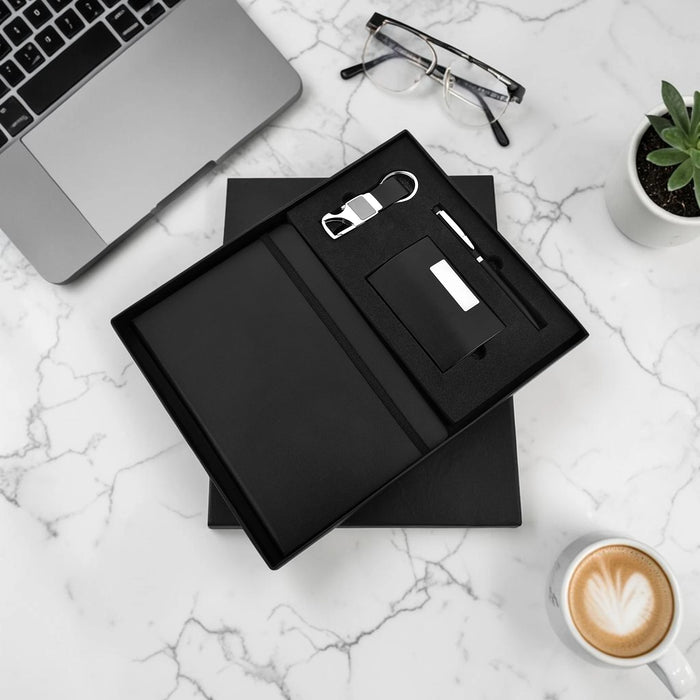 Black leather wallet set with bottle opener and cardholder on a marble surface with laptop, glasses, and coffee.
