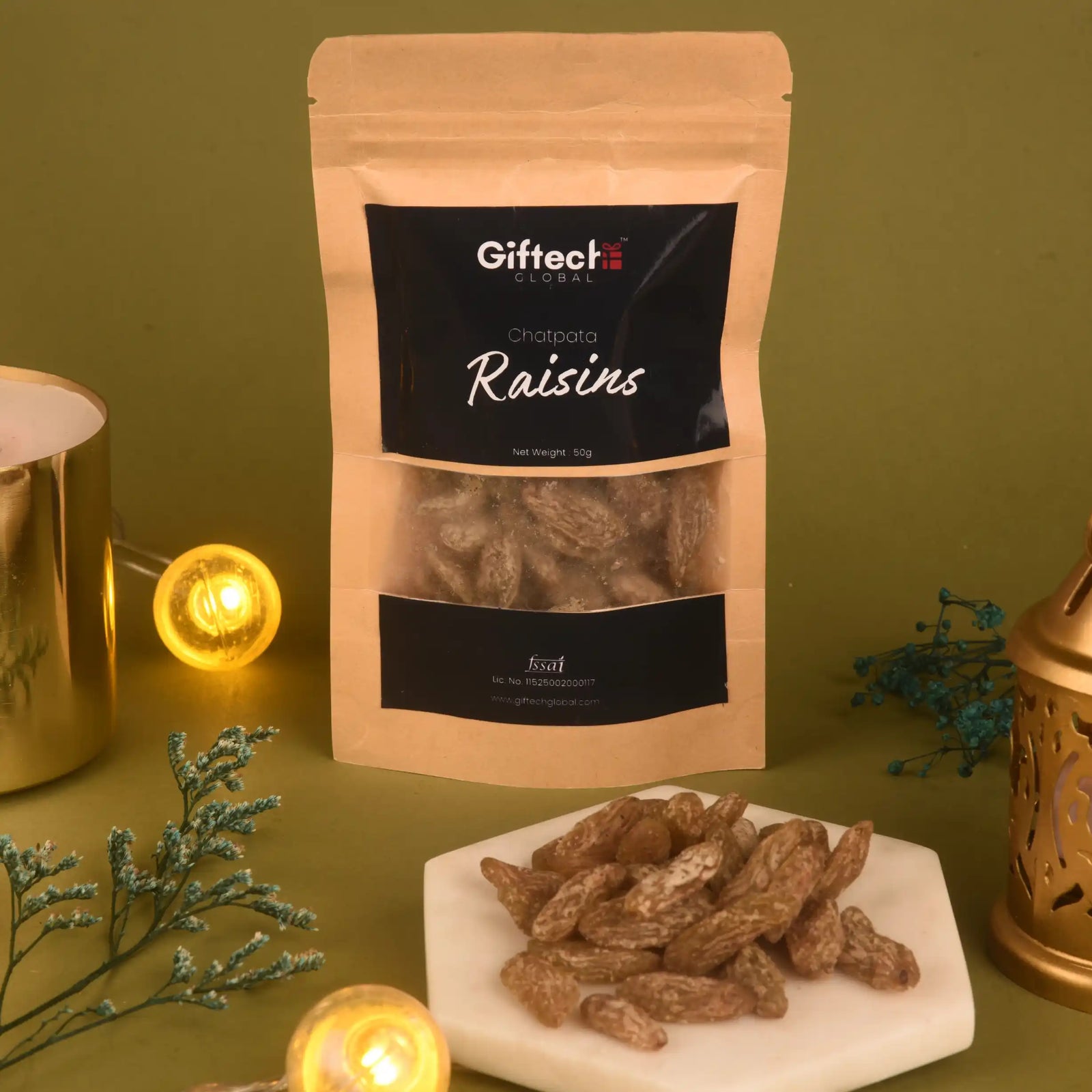 Chatpata Raisins – Tangy Spiced Snack in 50g pouch with visible dried fruits on marble plate. Ideal for dried fruit lovers seeking mixed spice flavor.