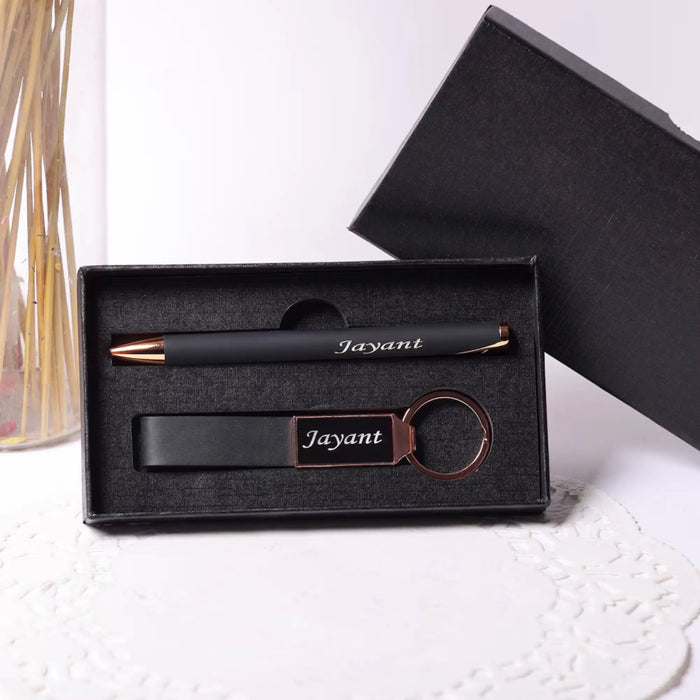 Black pen, keychain, and pen holder set with 'Jayant' engraving in a box on a white surface.