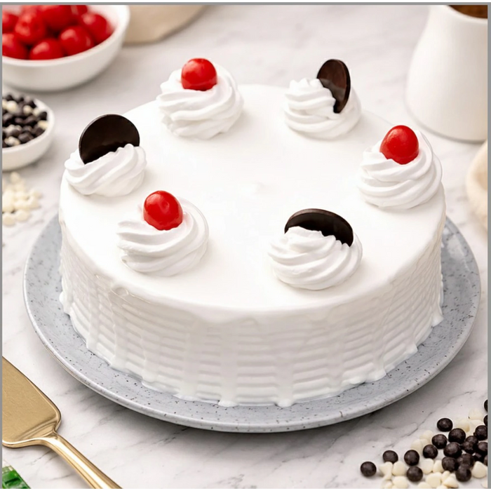Decorative cake with cherries and chocolate on white frosting