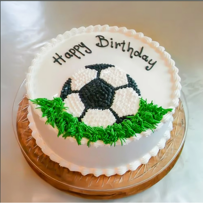 Football-themed birthday cake with green grass decoration