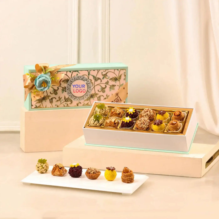 Blissful Bites Gourmet Hamper | Gift Hampers Online featuring an elegant box of assorted premium sweets with floral garnish, ideal for festive gifting.