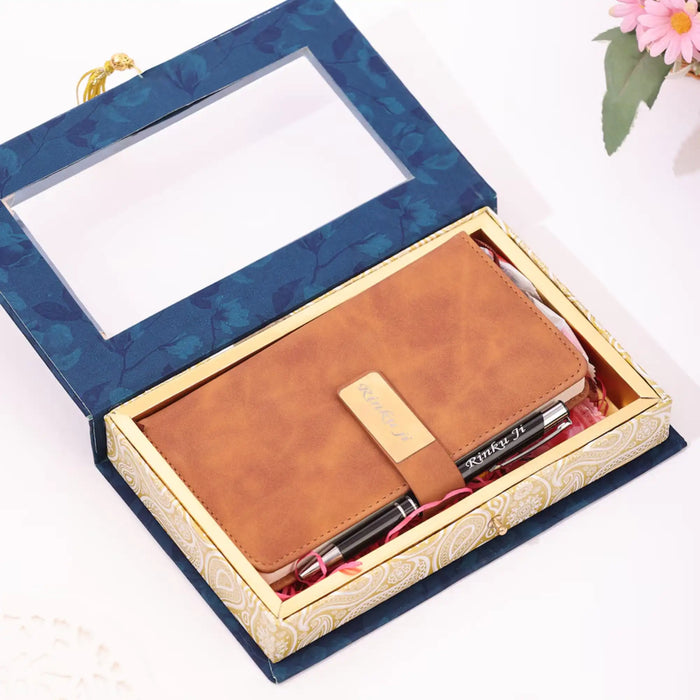 Brown leather notebook with pen set in a decorative box on a white background