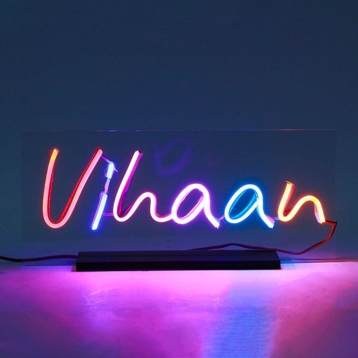 Personalized Custom Name Led Neon Sign in multicolor lights spelling 'Vihaan', mounted on a black base, ideal for home décor or gifting.