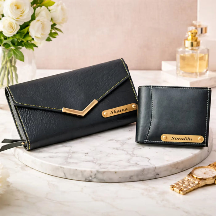 Two black handbags with gold accents on a marble surface, accompanied by flowers and a perfume bottle.