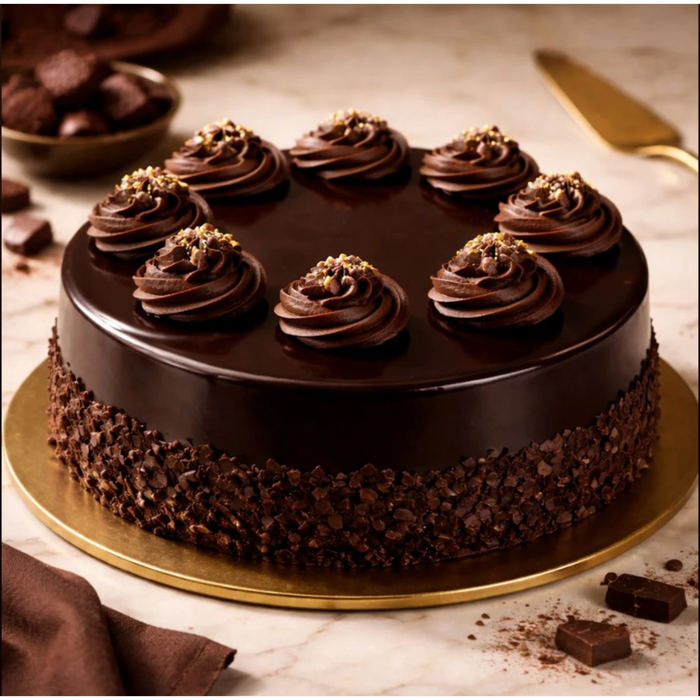 Chocolate cake with chocolate frosting and gold sprinkles