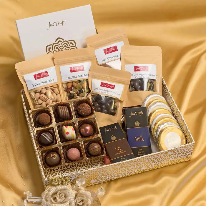 Wellness Gift Hamper - Chocolate 820g featuring assorted chocolates, hot chocolate mix, pistachios, and gourmet cookies in a decorative box